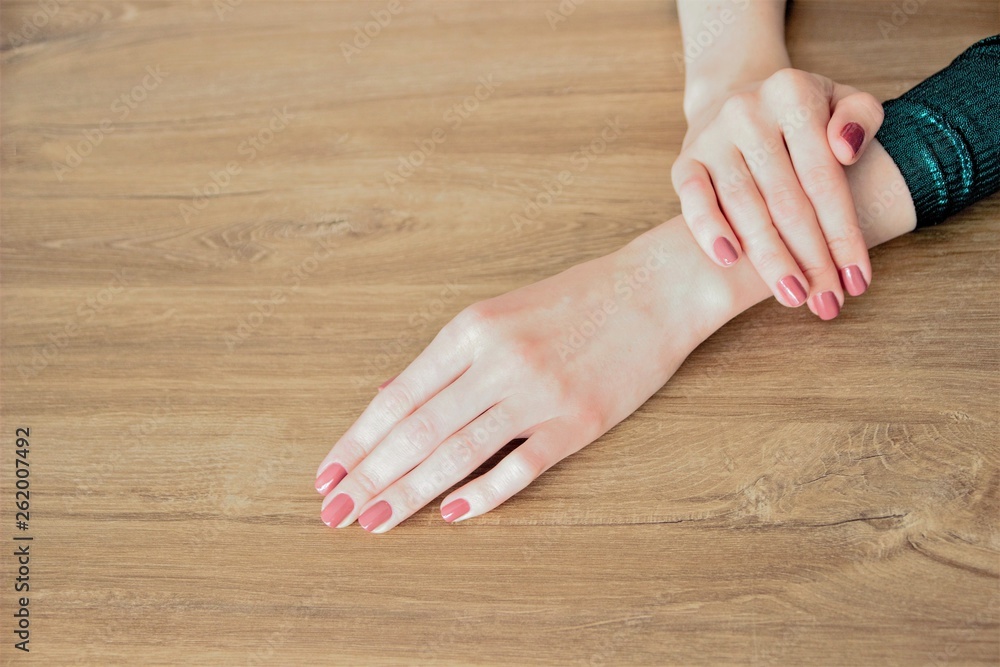 Stylish fashionable manicure. Hands of a beautiful young woman on a wooden background. selective focus. copy space Stylish fashionable manicure. Hands of a beautiful young woman on a wooden background. selective focus. copy space