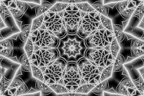 abstract mandala in space design with a circular ornament in the form of an interlacing of rays in the form of a star and geometric figures in a black and white version photo