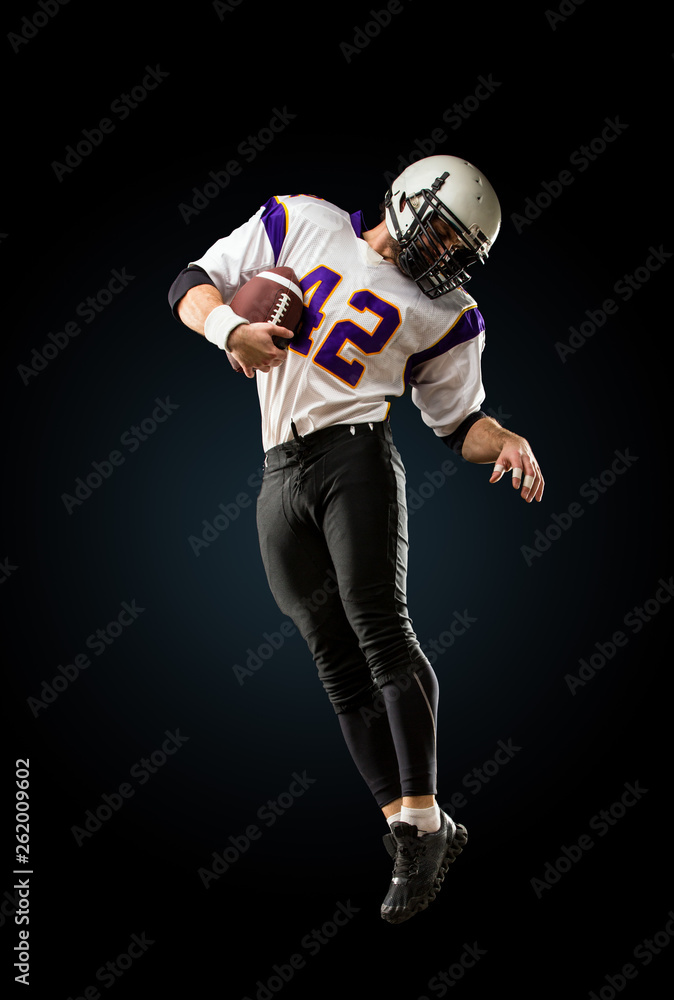 american football player in action. High jump of American football player