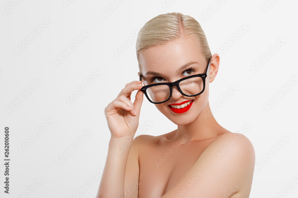 The concept of business and learning. A nice smiling blond girl with black glasses. Hipster. Young fashion and beauty model