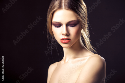 Beauty portrait of attractive young woman with clean skin pretty face. Closeup studio photo shoot