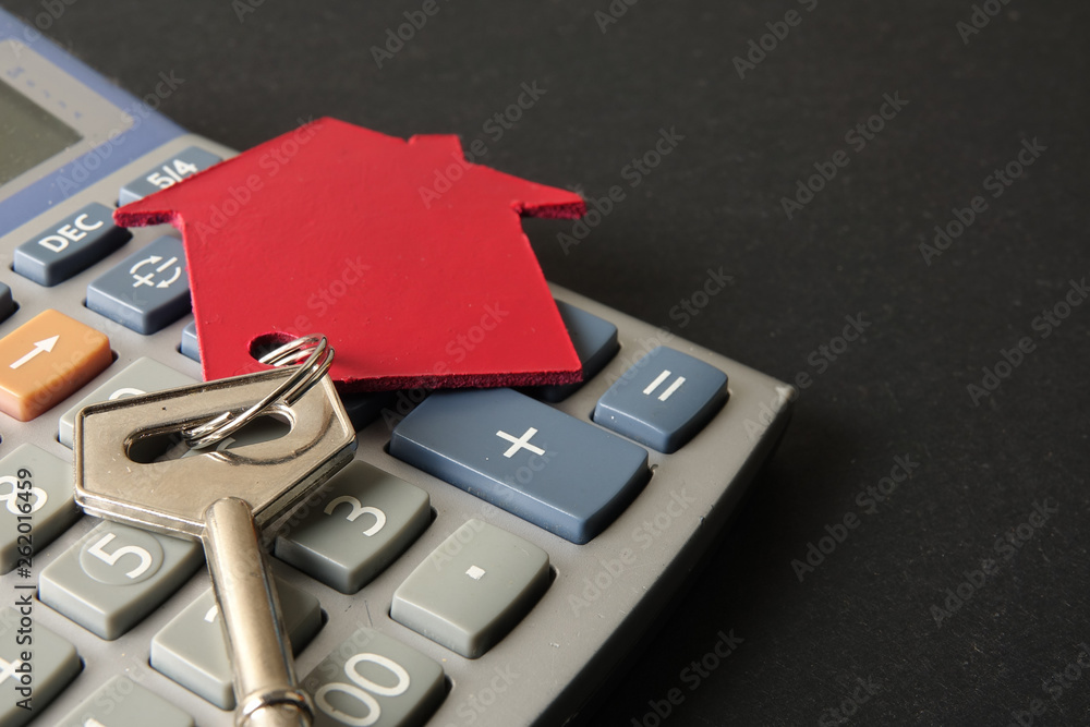 Property/housing ownership concept with red small house and steel key. Property/housing ownership concept with red small house and steel key.