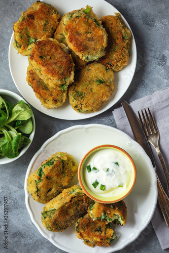 Homemade potato and spinach croquettes with yogurt dip.