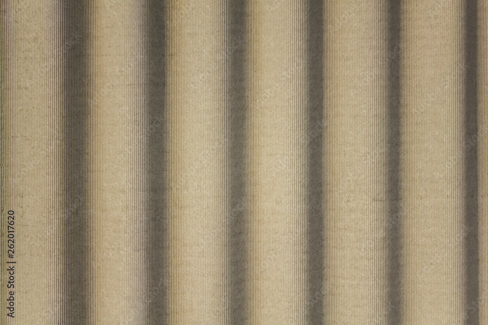 Fototapeta premium gray concrete shield with wavy relief and shadows. vertical lines. rough surface texture