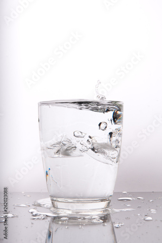 glass of water with ice on white background