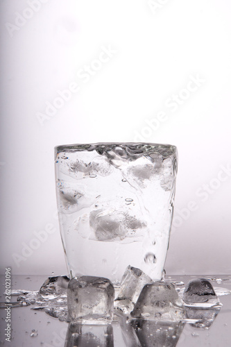 glass of water with ice on white background