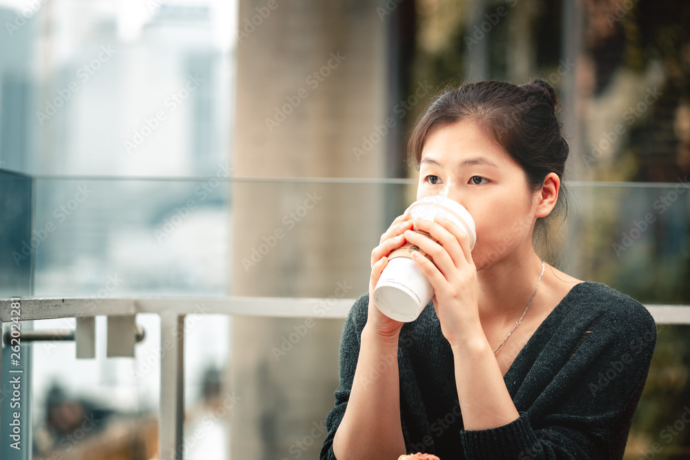 Young woman drinking coffee and eating a delicious muffin cake in cafe, Young woman drinking coffee and eating a delicious muffin cake in cafe,