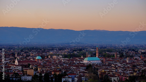 wide panorama during the sunset of the city of Vicenza and the famous monument called Basilica Palladiana with the tall Clock Tower. Vicenza, Veneto, Italy - April 2019