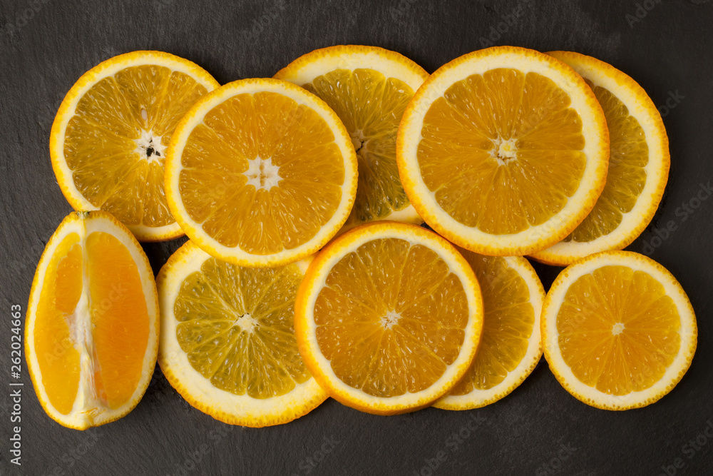 fresh orange slices on dark natural background, top view. Space for text fresh orange slices on dark natural background, top view. Space for text