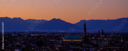 wide panorama during the sunset of the city of Vicenza and the famous monument called Basilica Palladiana with the tall Clock Tower. Vicenza, Veneto, Italy - April 2019