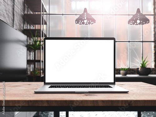 Laptop with blank screen mockup template on table in industrial old factory loft interior - front view © guteksk7