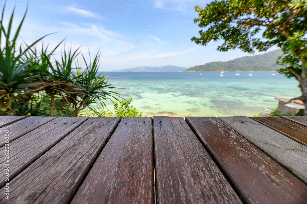 Wooden tabletop on tropical sea in summer