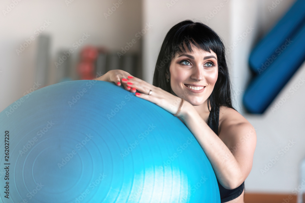 Fototapeta premium Fitness woman exercise with ball in gym. Individual sport to fit muscles of body for healthy life concept.