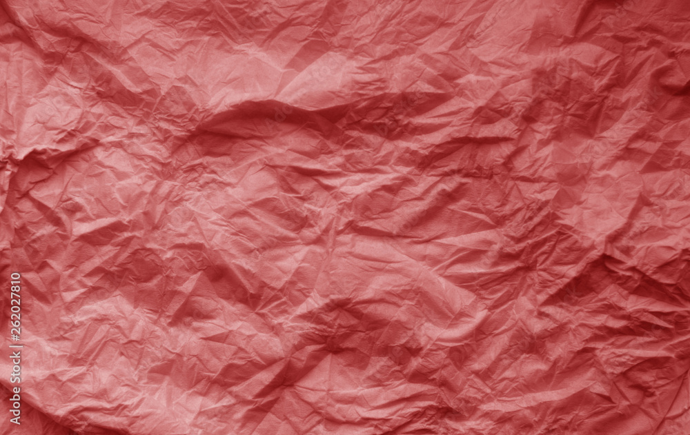 Fototapeta premium Crumpled sheet of paper in red color.