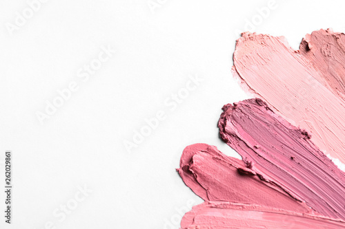 Lipstick smears isolated on white, top view. Space for text