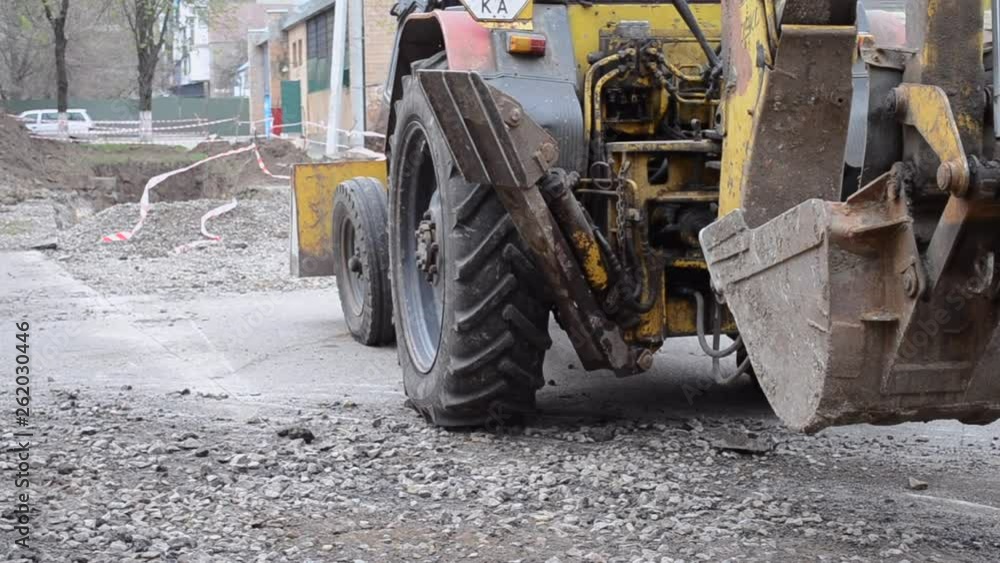 Tractor stands near dug pits. Tractor stands near dug pits.