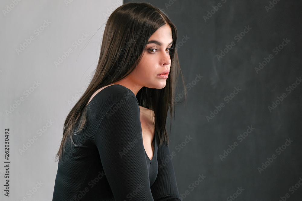 Let's talk. Studio photo portrait of a cute young Caucasian beautiful brunette girl with long fringes looking straight into the camera on a colored background. Let's talk. Studio photo portrait of a cute young Caucasian beautiful brunette girl with long fringes looking straight into the camera on a colored background.