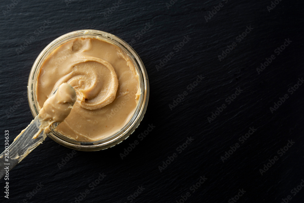 Peanuts and Fresh Peanut Butter Isoalted Black Background Protein Super Food Snack with copy space Peanuts and Fresh Peanut Butter Isoalted Black Background Protein Super Food Snack with copy space