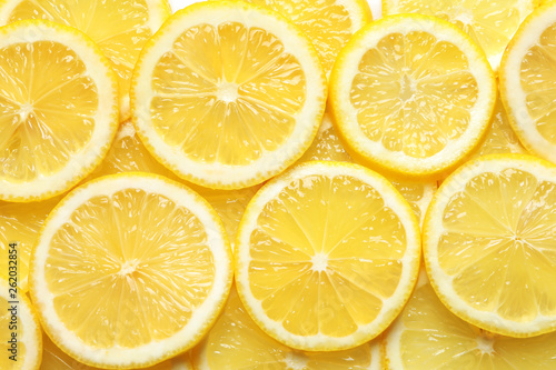 Juicy lemon slices as background, top view. Citrus fruit