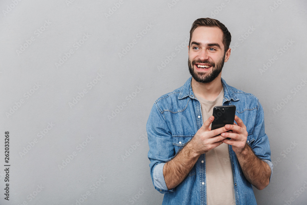 Excited cheerful man wearing shirt standing isolated Excited cheerful man wearing shirt standing isolated