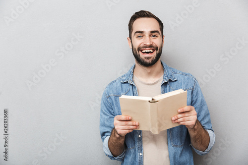 Excited cheerful man wearing shirt standing isolated