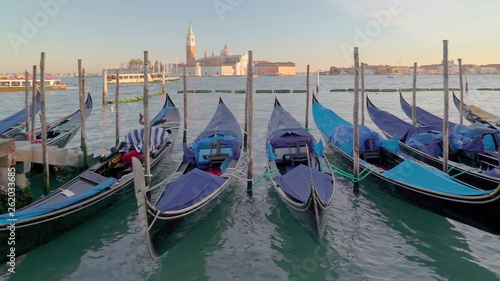 15030_A_row_of_black_gondolas_tied_on_each_poles_in_Venice_Italy.jpg © Nordicstocks