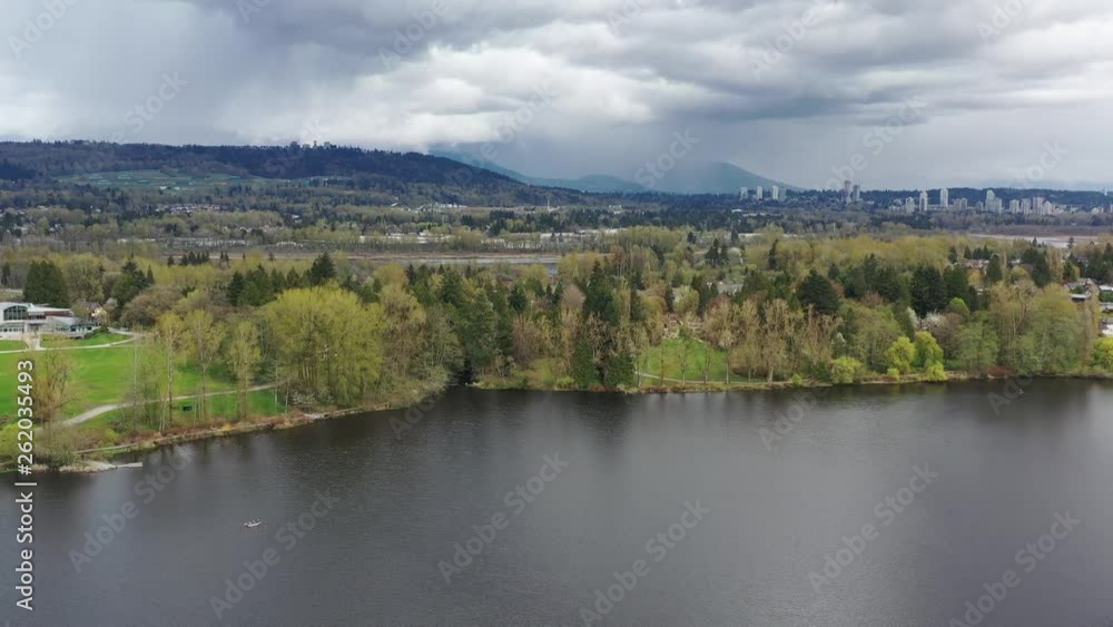Aerial View at Mountain Lake with Dramatic Clouds in British Columbia, Canada. 4K. Aerial View at Mountain Lake with Dramatic Clouds in British Columbia, Canada. 4K.