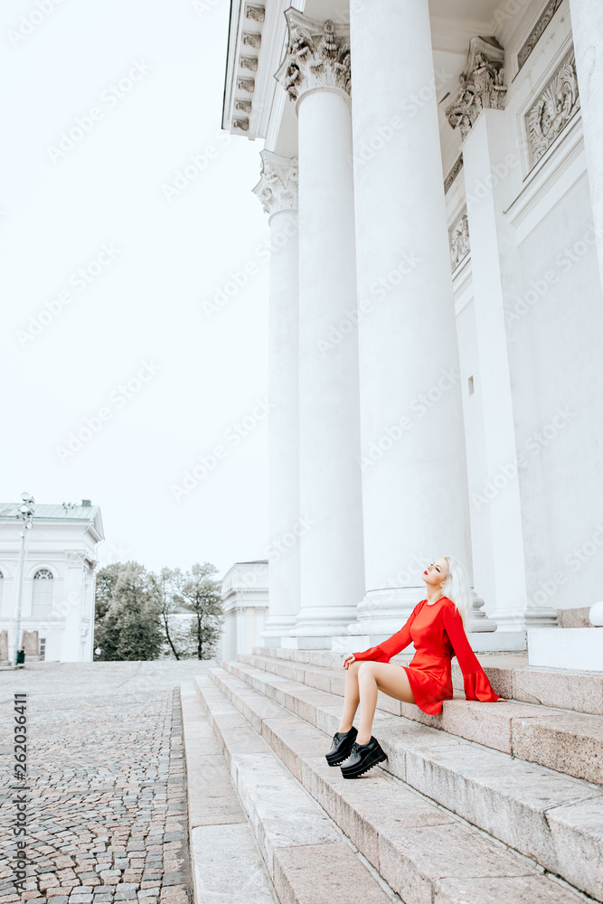 Lady in red dress and black boots posing Lady in red dress and black boots posing