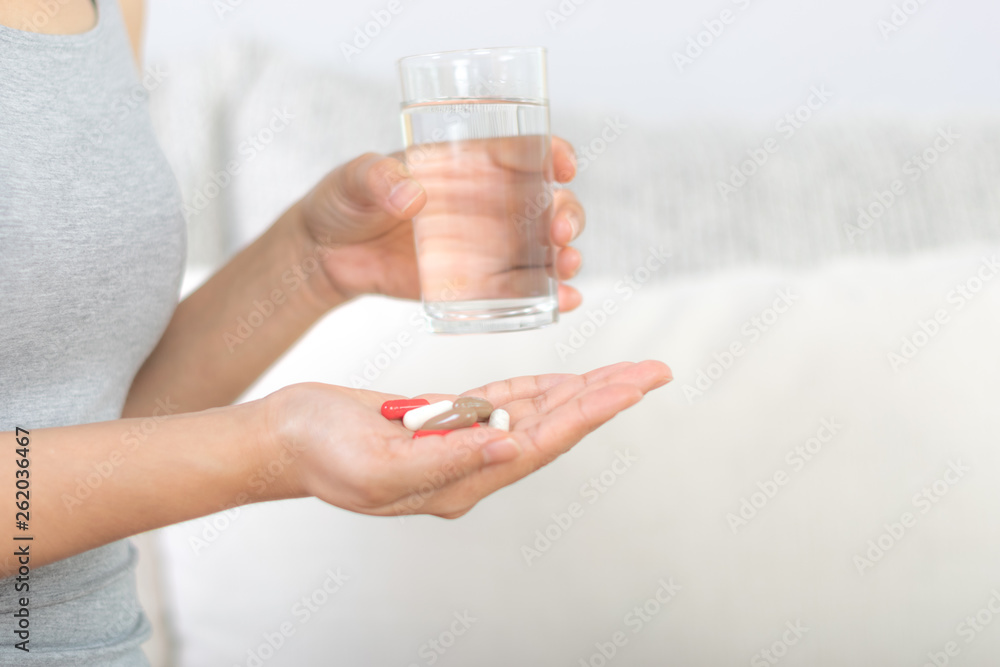 Close up of woman taking in pill, Medicine, health care and people concept. Copy space for advertisers. Close up of woman taking in pill, Medicine, health care and people concept. Copy space for advertisers.