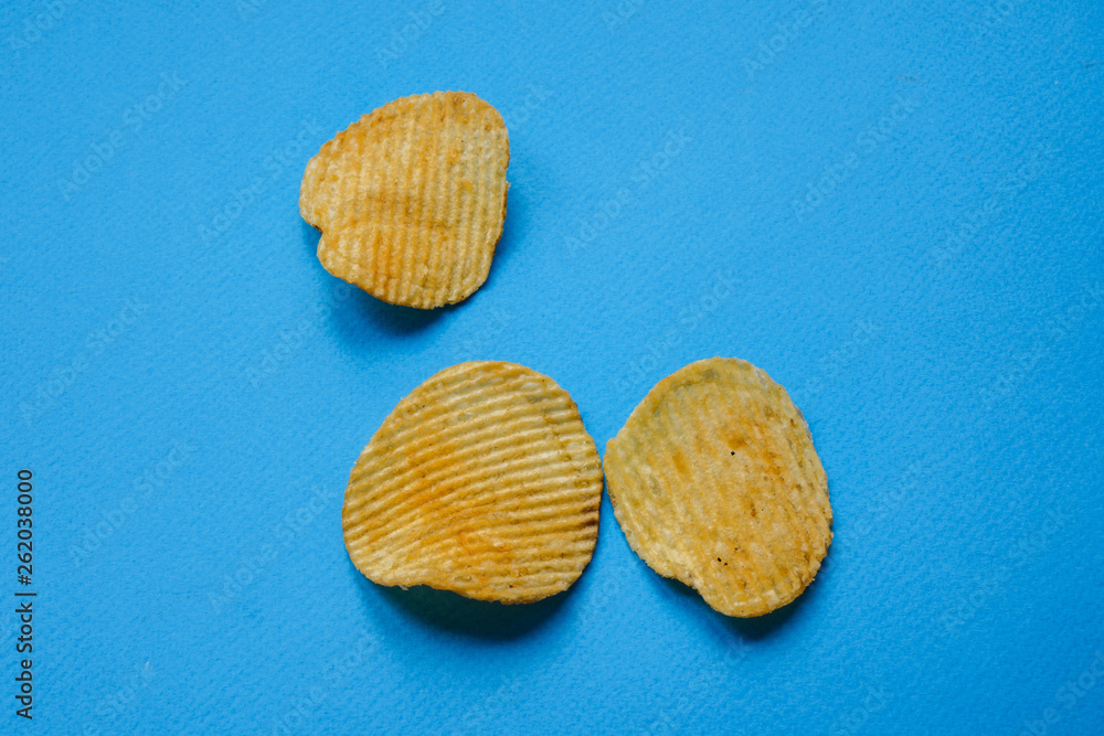 crispy potato chips on blue background. nachos chips crispy potato chips on blue background. nachos chips