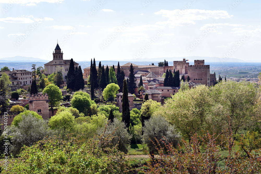 View of the bell tower of the Alhambra from the Generalife gardens on a bright summer day in Granada, Spain
