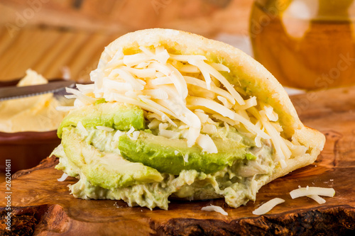 Typical Latin American food, arepa for breakfast with cheese, avocado and chicken photo