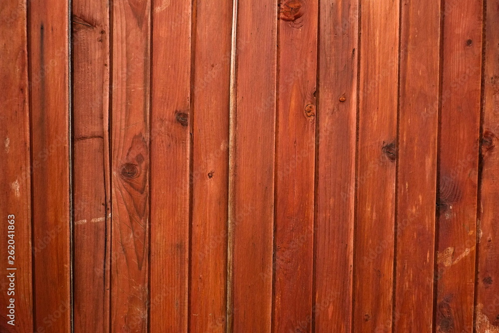 Rustic background of wooden boards. Fence made of vertical brown planks Rustic background of wooden boards. Fence made of vertical brown planks
