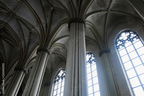 View of gothic medieval cathedral interior with columns and large windows. The Church of Sts. Olha and Elizabeth