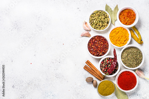 Fototapeta Naklejka Na Ścianę i Meble -  Colored indian spices on white table.