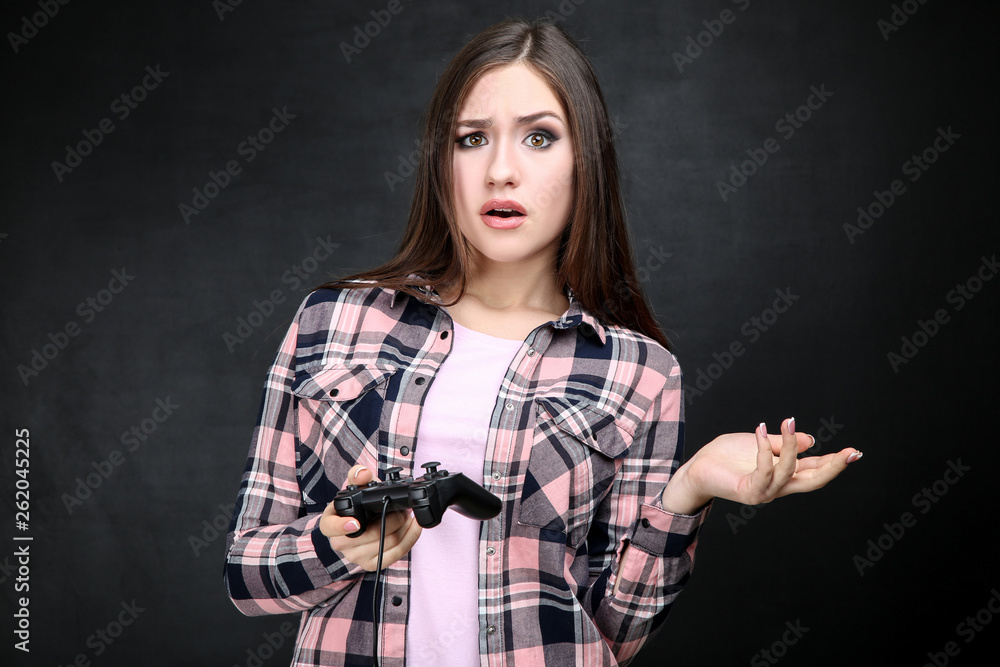 Beautiful girl with joystick on black background Beautiful girl with joystick on black background