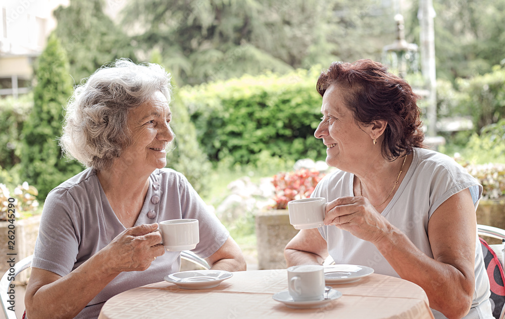 Senior women drinking coffee and talking Senior women drinking coffee and talking