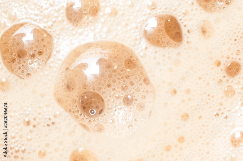 A large gullet of a foamy tonic of coffee with milk or cream, whipped with a spetsialny instrument, close-up macro shooting for desktop wallpapers A large gullet of a foamy tonic of coffee with milk or cream, whipped with a spetsialny instrument, close-up macro shooting for desktop wallpapers