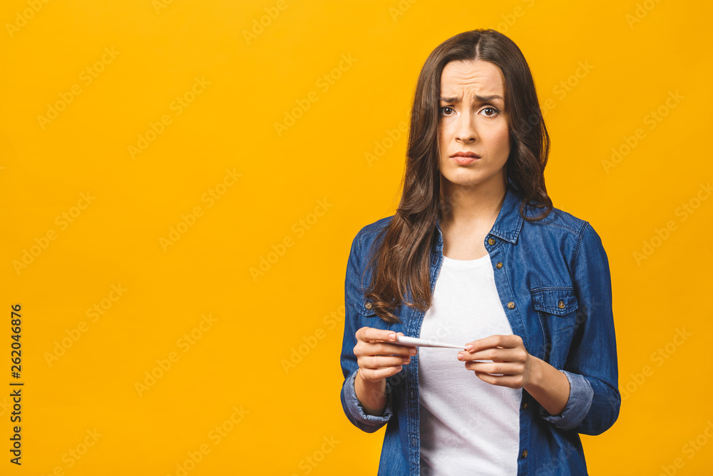 Young woman having flue taking thermometer. Isolated against yellow background. Beautiful young woman is sick with a high temperature, a thermometer, isolated close-up. Cold, flu concept. Young woman having flue taking thermometer. Isolated against yellow background. Beautiful young woman is sick with a high temperature, a thermometer, isolated close-up. Cold, flu concept.