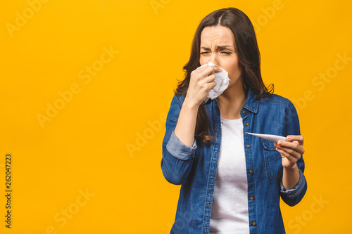 Fototapeta Young woman having flue taking thermometer
