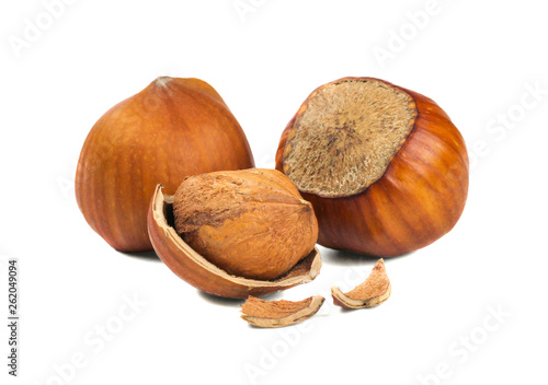 Three hazelnuts and a nutshell. Isolated picture.