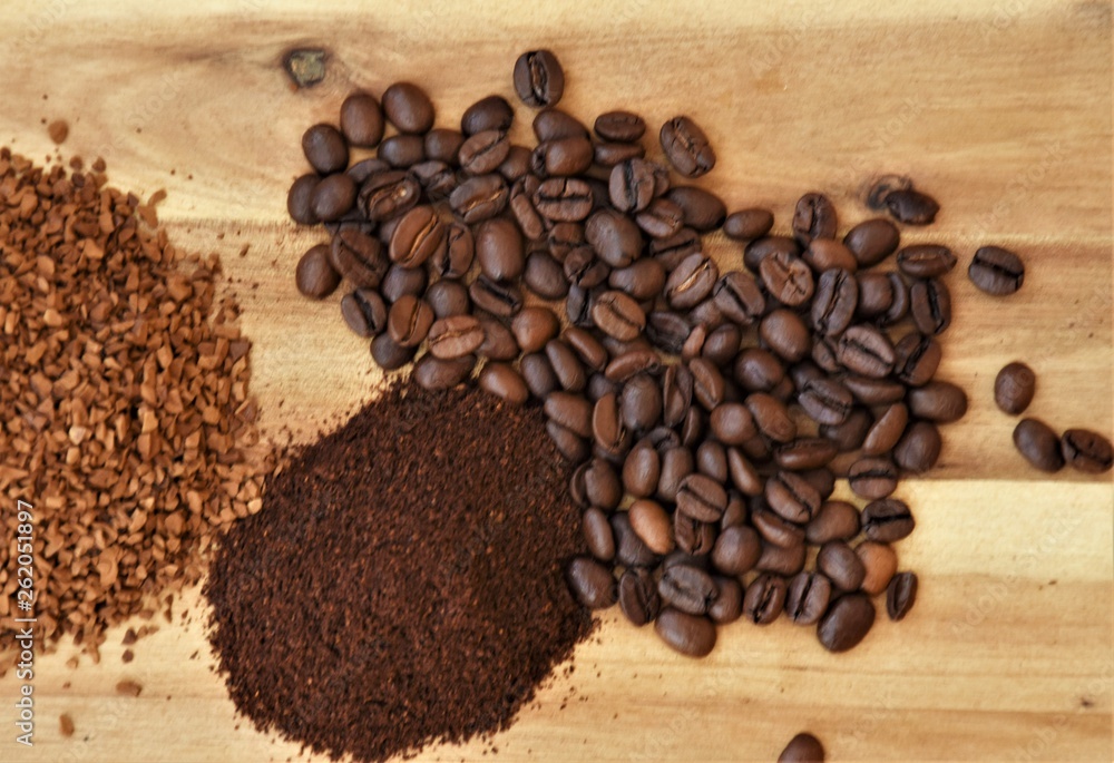 grain, ground and granules of coffee on a wooden background grain, ground and granules of coffee on a wooden background