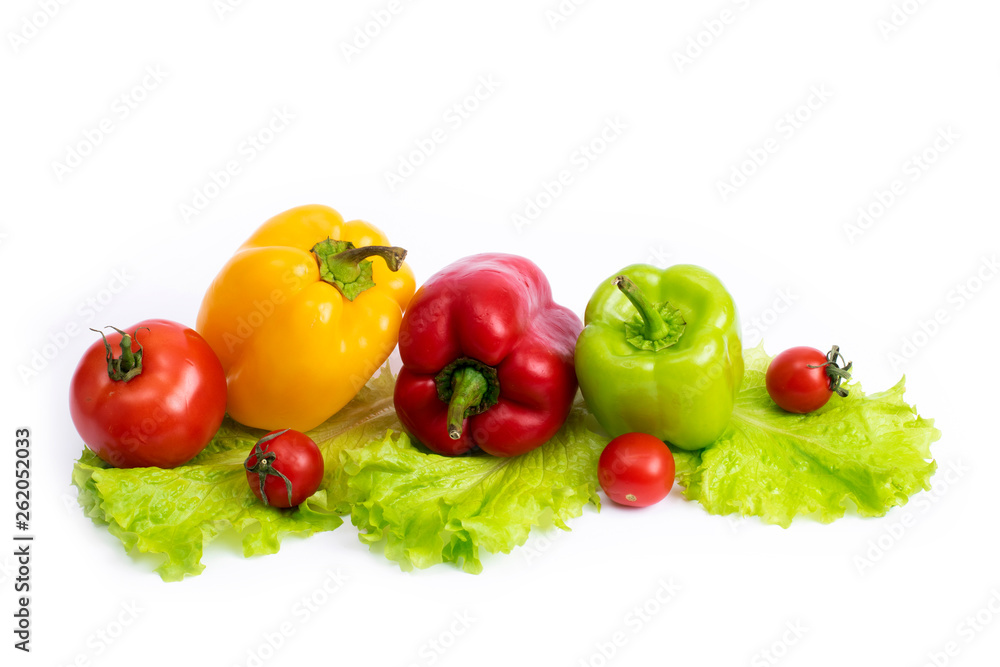 Cherry tomatoes with greens and sweet peppers on a white background. Green pepper and yellow with tomatoes and herbs on a white background.. Cherry tomatoes with greens and sweet peppers on a white background. Green pepper and yellow with tomatoes and herbs on a white background..