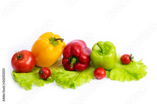 Fototapeta Naklejka Na Ścianę i Meble -  Cherry tomatoes with greens and sweet peppers on a white background. Green pepper and yellow with tomatoes and herbs on a white background..