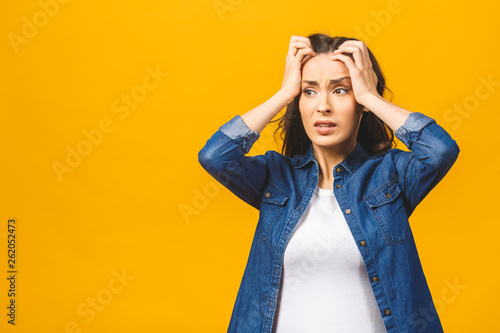 Young beautiful woman over isolated background suffering from headache desperate and stressed because pain and migraine. Hands on head. photo