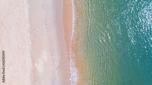 Aerial view of Beach with shade emerald blue water and wave foam on tropical sea