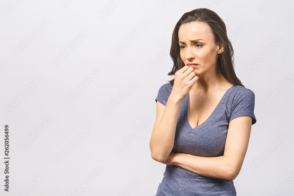 Studio shot of displeased European woman frowns face in discontent, cries from pain, wears casual, models over white studio wall. People, depression, negative feelings. Studio shot of displeased European woman frowns face in discontent, cries from pain, wears casual, models over white studio wall. People, depression, negative feelings.
