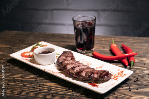 georgian grilled kebab meat with pepper and wine on wooden background;