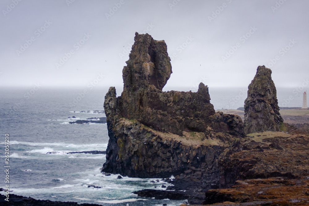 Gothic landscape with rock, skyline, ocean, and high clouds - Iceland