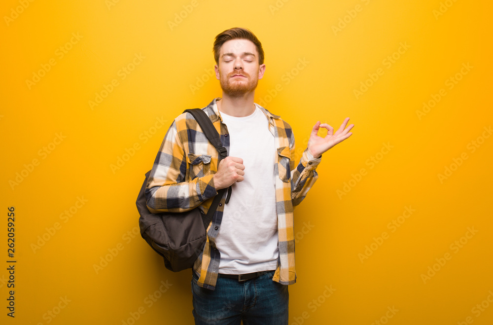 Young redhead student man performing yoga Young redhead student man performing yoga